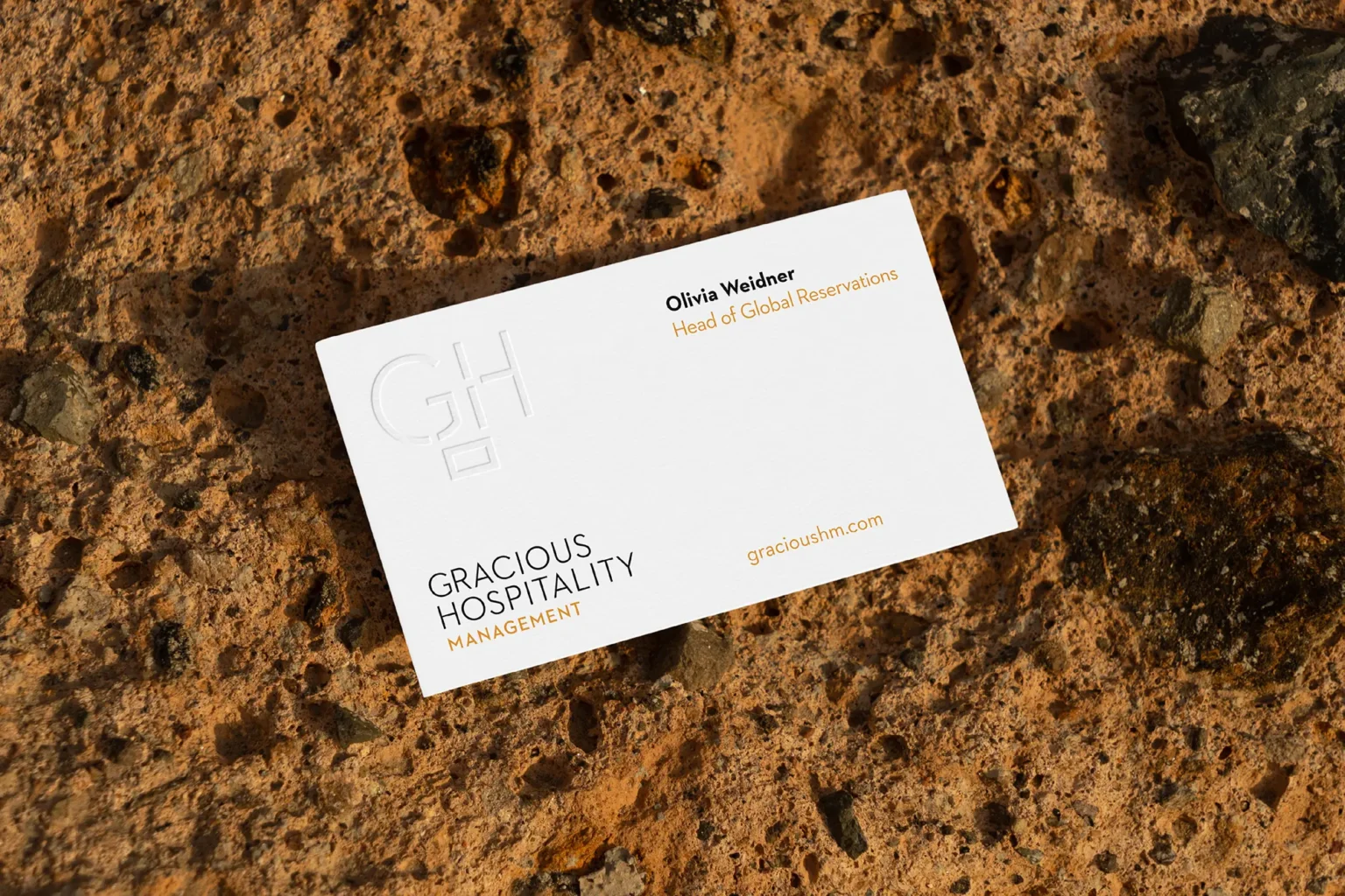 Gracious Hospitality business cards featuring a large "GH" monogram in white blind embossing, locally printed in NYC for a sophisticated and clean branding look.