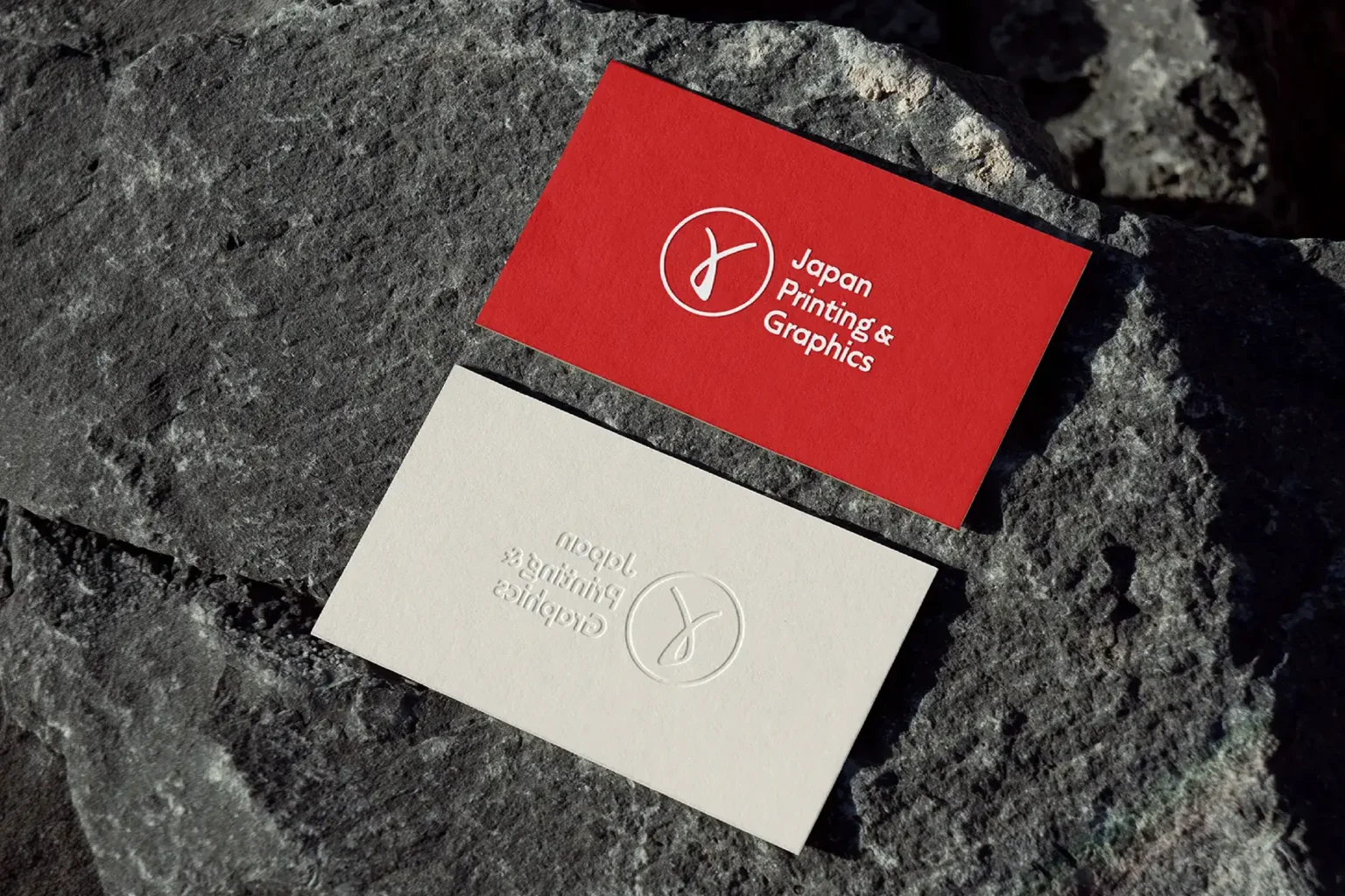 Vibrant red and white business cards for Japan Printing & Graphics with a raised embossed logo, handcrafted at our local NYC print shop.