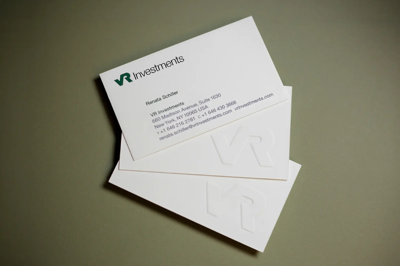 Stacked VR Investments business cards featuring a large, bold embossed monogram on extra-thick white cardstock for a memorable, touchable finish.