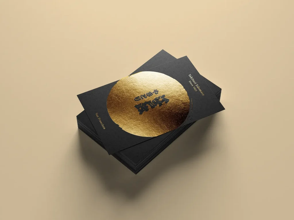 High-end hospitality business cards featuring large metallic gold foil circles on 600 GSM black premium paper, crafted in our NYC print shop.
