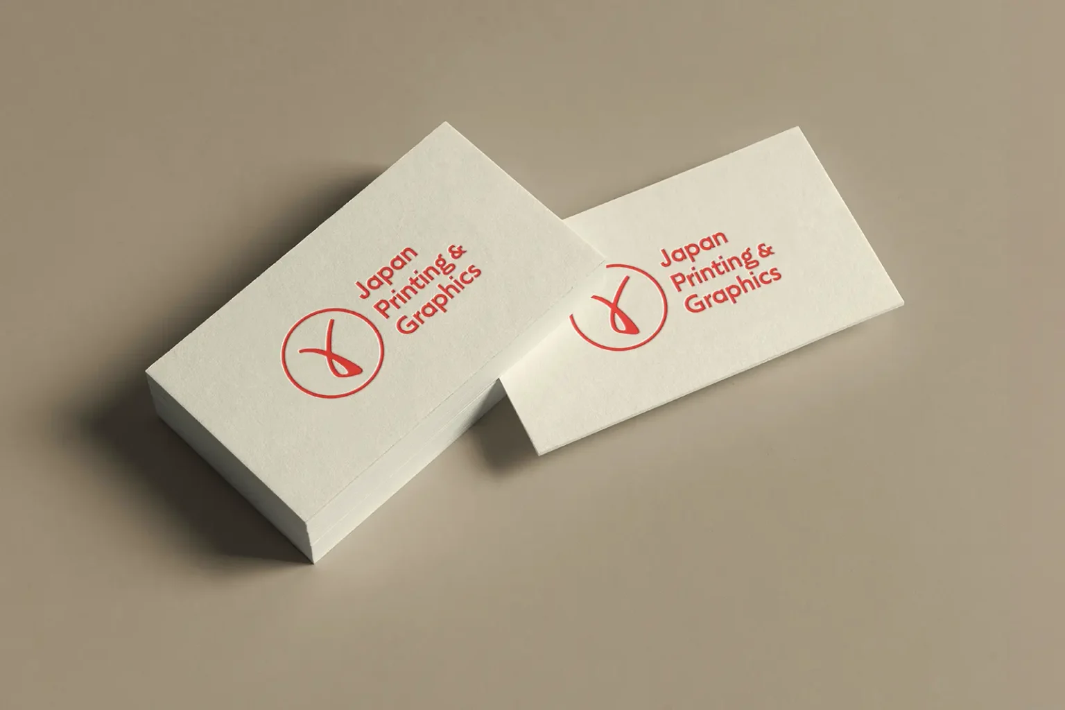 Professional cream-colored business cards for Japan Printing & Graphics with red letterpress ink, custom-printed at our local Manhattan shop.