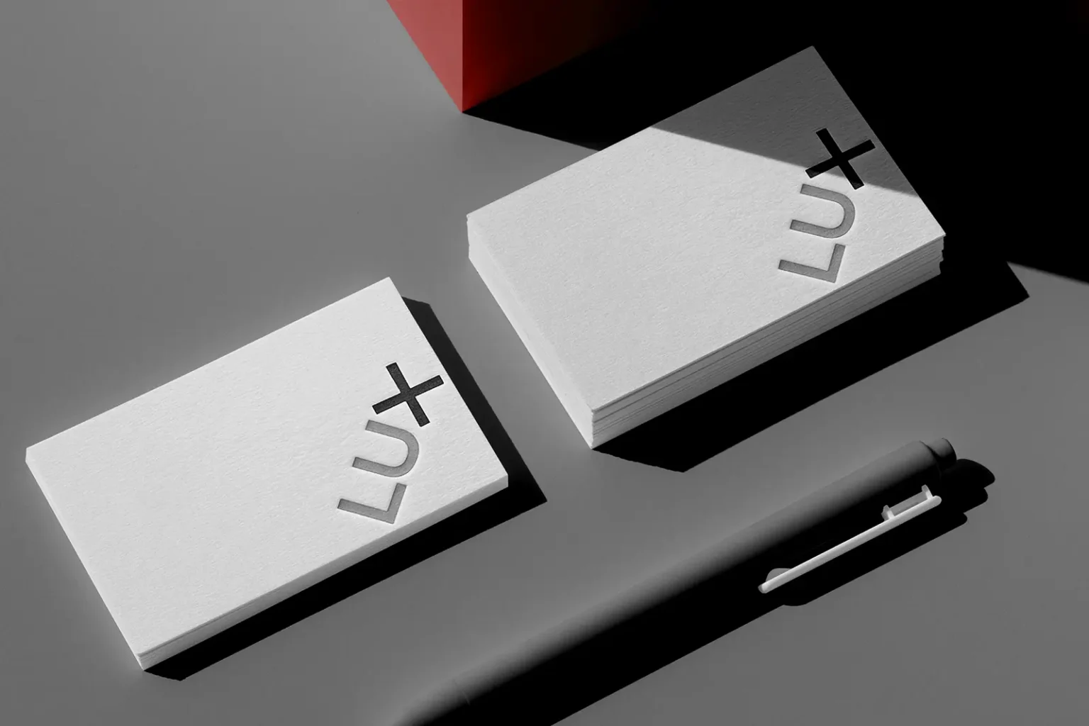 Close-up of LUX+ business cards showing the deep "bite" of letterpress printing on extra-thick cotton paper, crafted by our print experts.