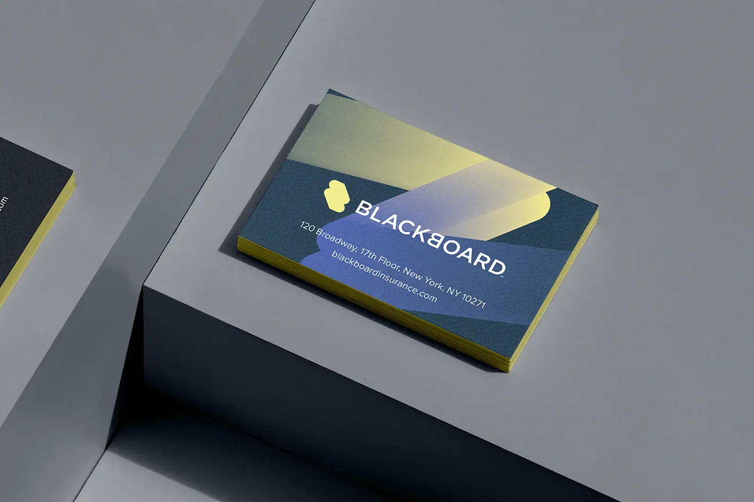 Custom multi-colored business cards for Blackboard with neon yellow painted edges, designed to grab attention with a vibrant and eye-catching finish.