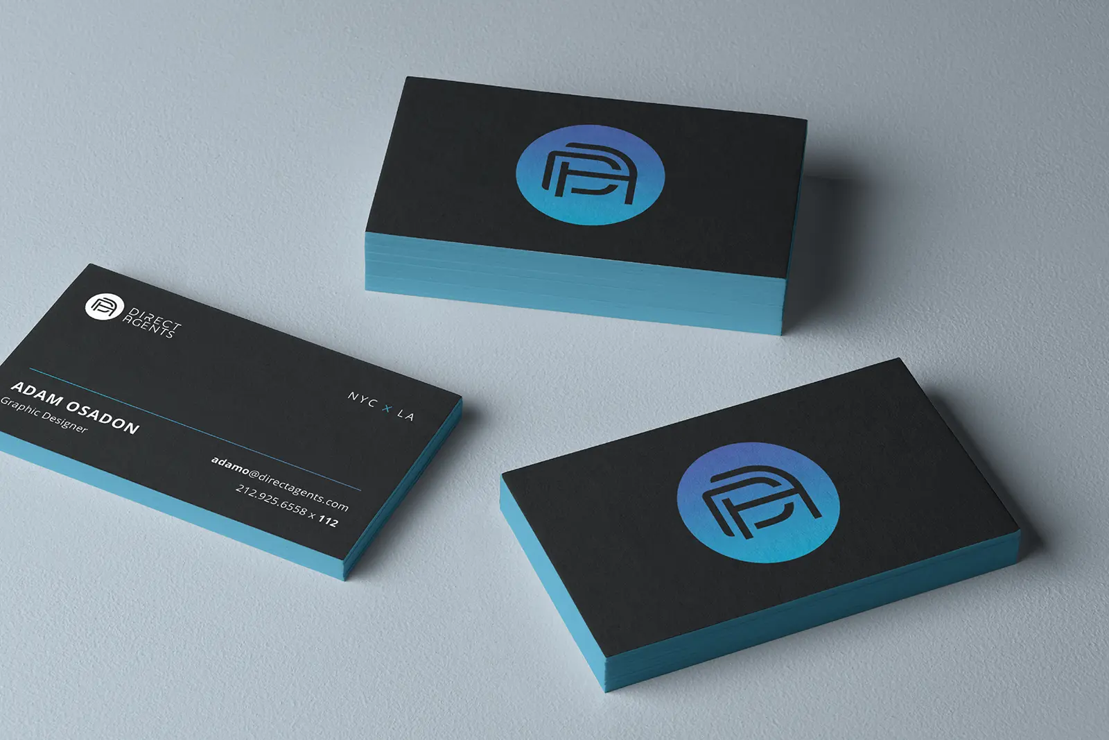 Minimalist black business cards with electric blue colored edges, professionally printed in Manhattan for a modern and luxurious branding aesthetic.