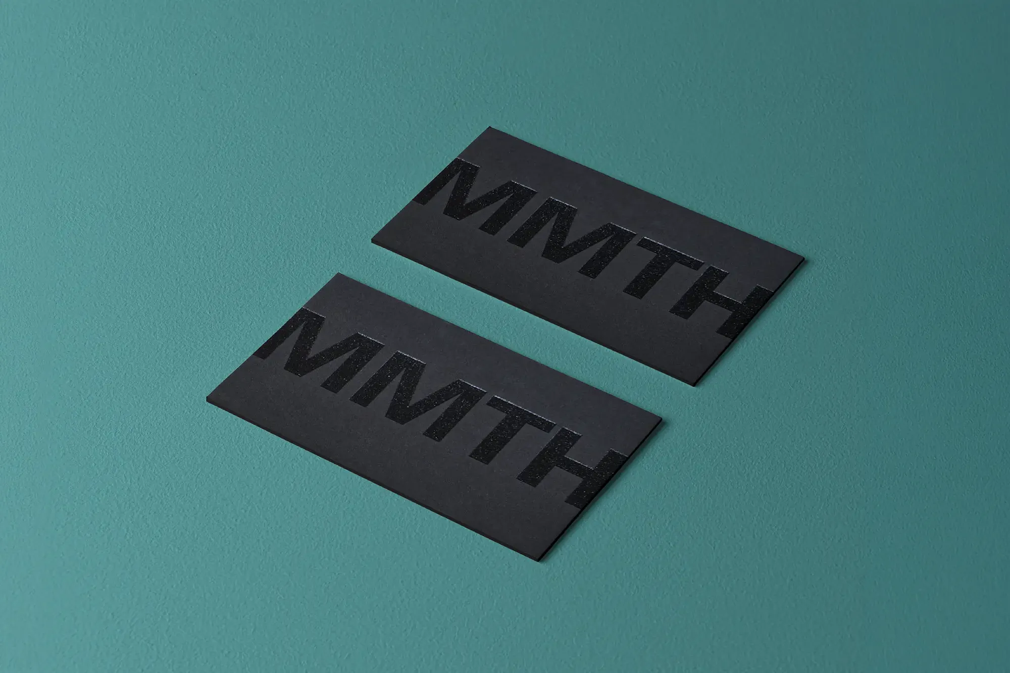Luxury black-on-black business cards for MMTH featuring matte black raised ink on premium matte stock, locally printed in Manhattan for a high-end, minimalist finish.