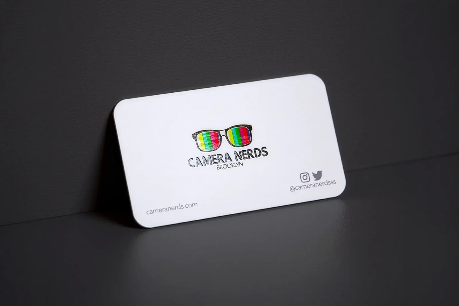 Rounded corner white business cards for Camera Nerds, featuring vibrant spot gloss on the colorful glasses logo for our Brooklyn-based creative partners.