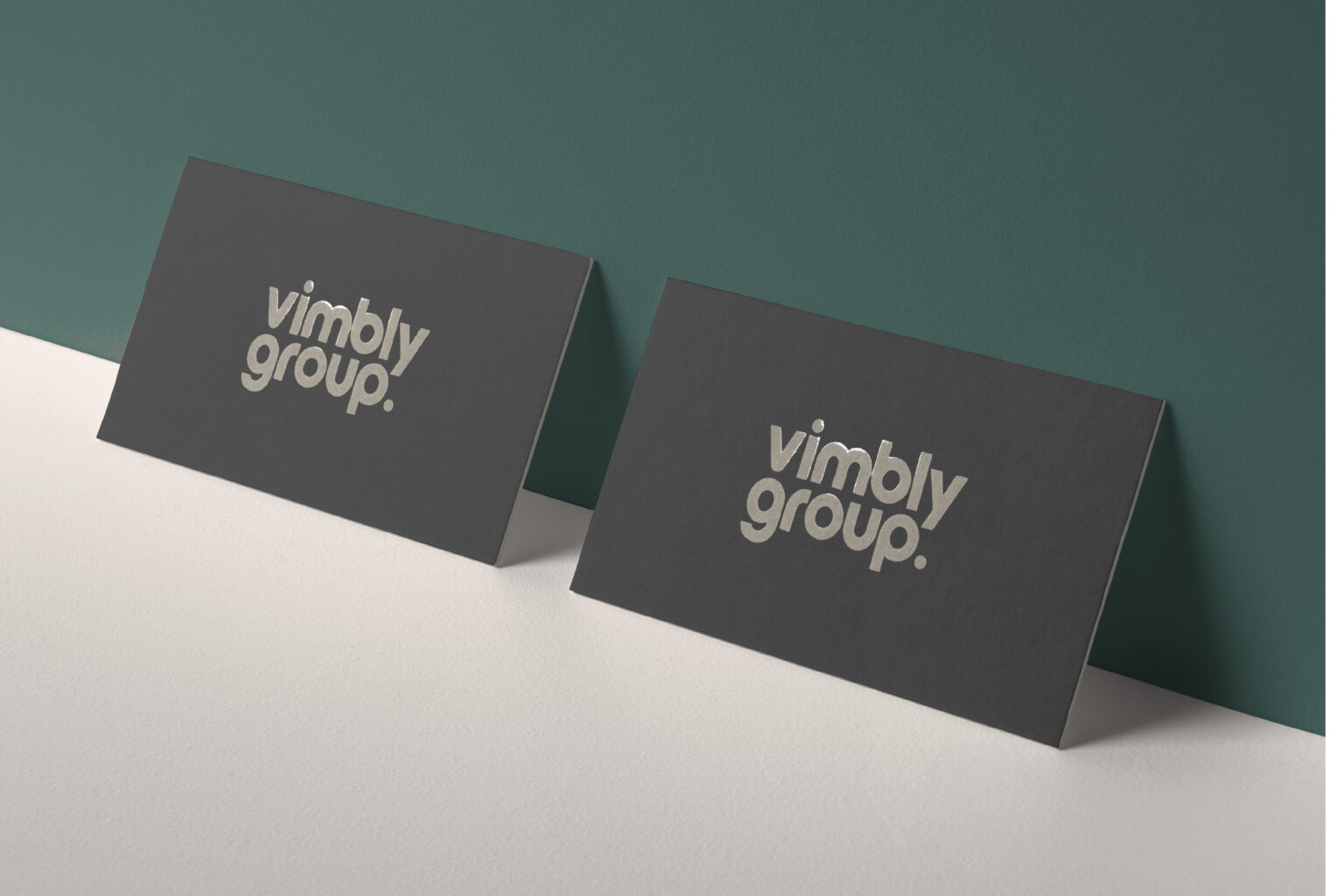 Modern grey business cards for Vimbly Group with clear spot gloss lettering, custom-crafted at our New York City-based print shop.