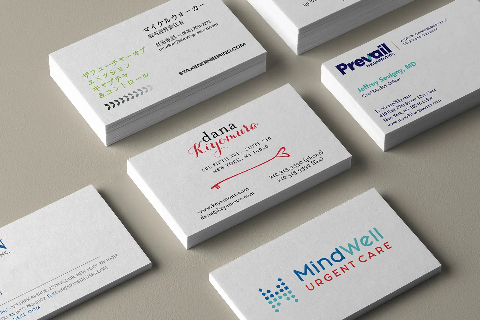 A collection of premium rush business cards, including Dana Kiyomura and MindWell Urgent Care, serving our customers in Brooklyn with quick 24-hour printing.