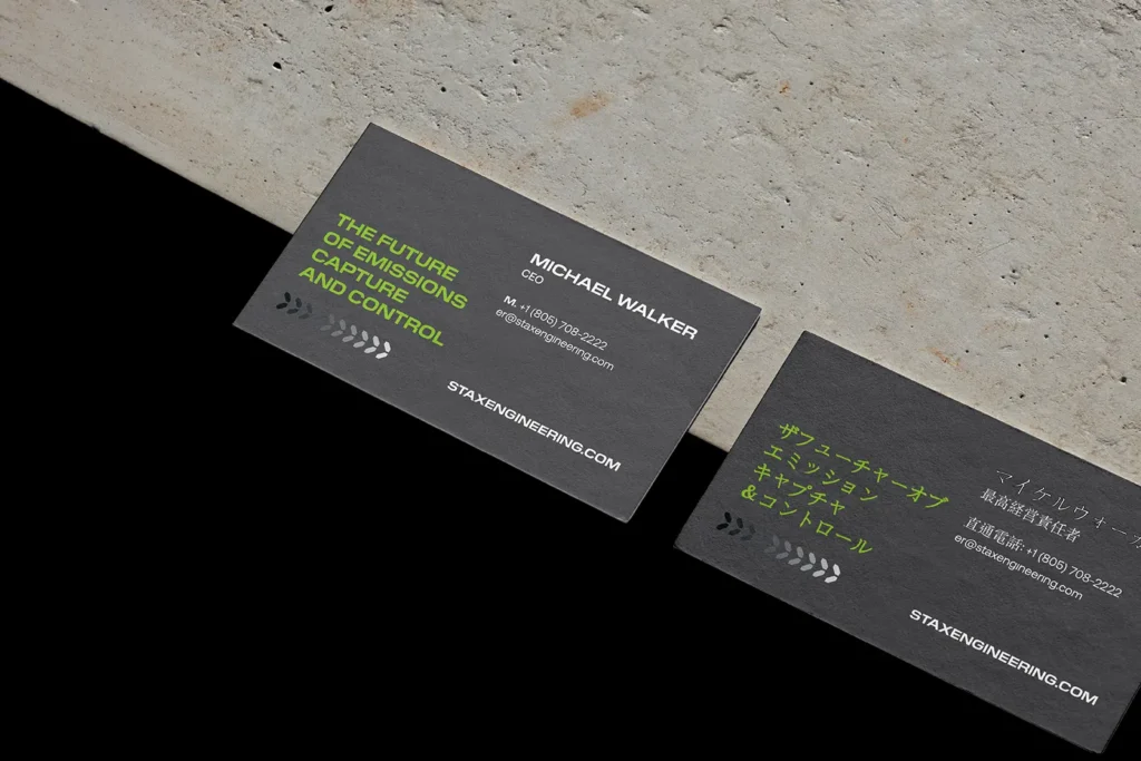 Technical business cards for Stax Engineering featuring neon green accents and Japanese typography, expertly crafted at our facility with Japanese precision.