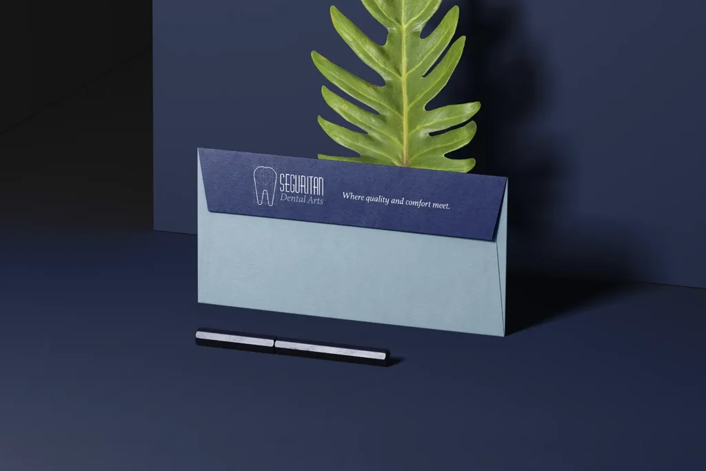 Professional two-tone envelopes for Seguritan Dental Arts featuring a dark navy flap on light blue stock, custom-made for our medical and dental partners in Brooklyn.