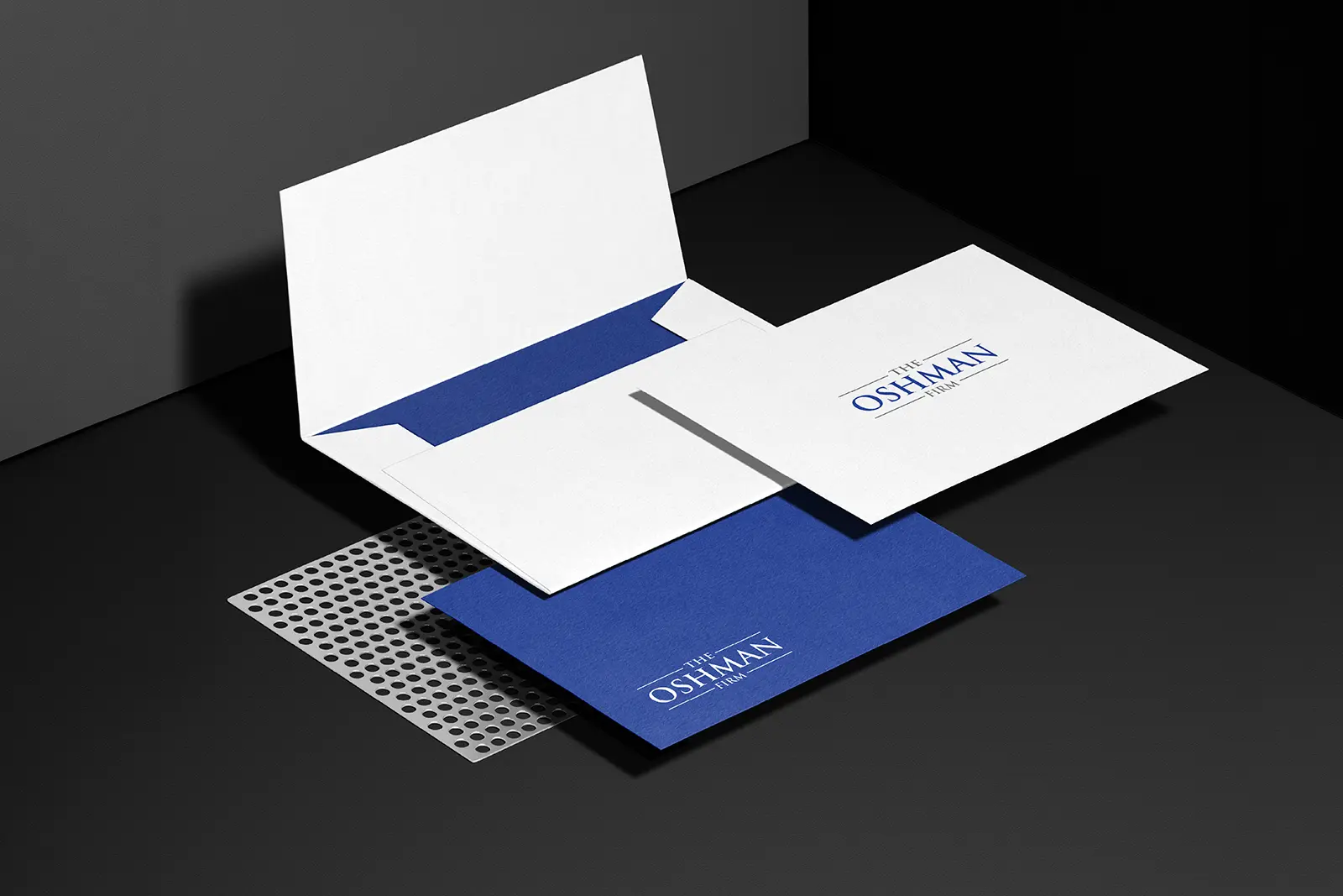 Branded #10 envelopes for The Oshman Firm printed on 24lb Classic Crest Solar White paper at our NYC print shop, featuring a clean royal blue and white corporate design.