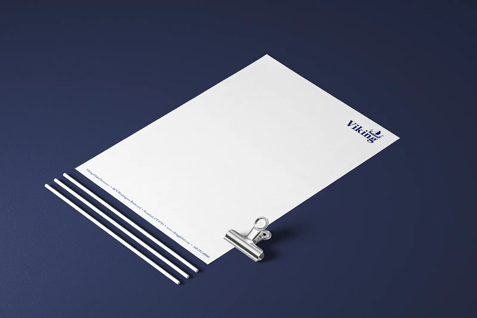 Custom corporate letterhead featuring a blue logo and held by a silver binder clip, printed on premium official stationery for our clients throughout Brooklyn and NYC.