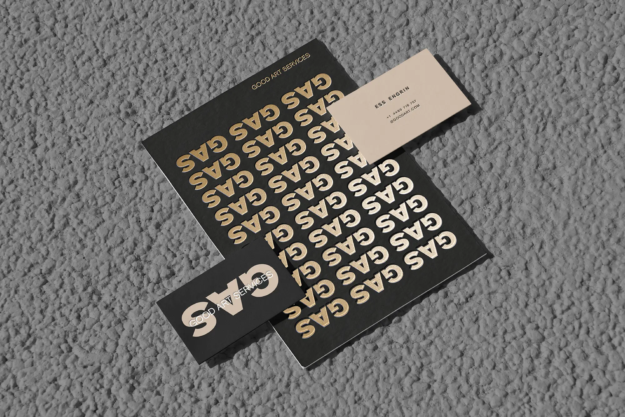 Bold typographic brand identity for a Brooklyn-based client, featuring gold foil printing and styled on a textured concrete slab.