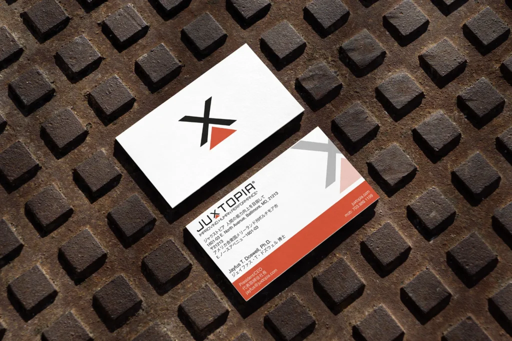 Durable bilingual business cards for a tech brand, printed on 18pt premium cardstock and styled on a textured surface in Manhattan.