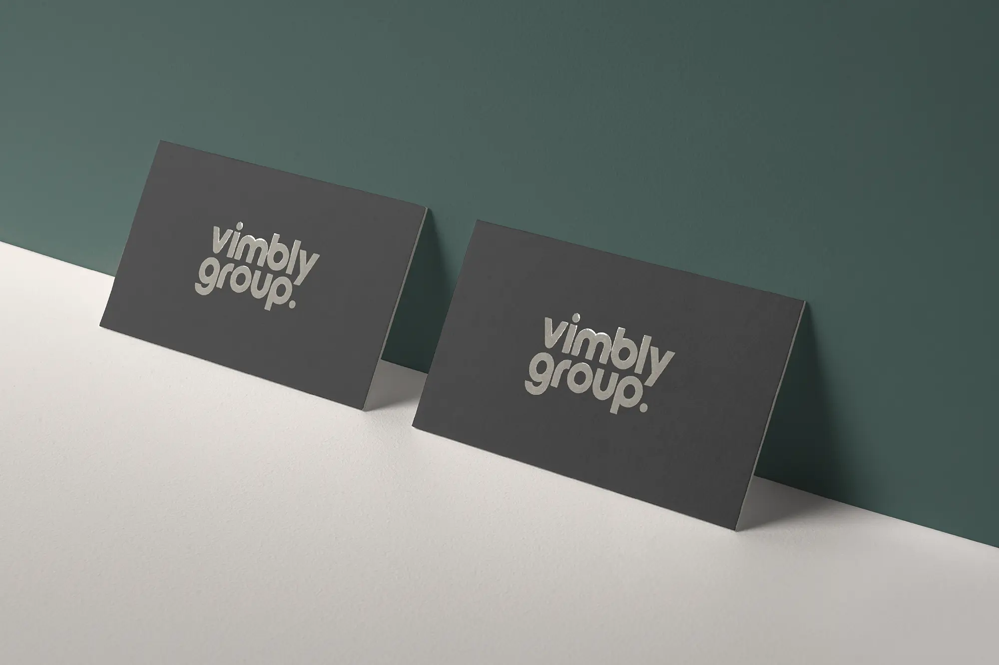 Modern grey business cards for Vimbly Group with clear spot gloss lettering, custom-crafted at our NYC-based print shop.