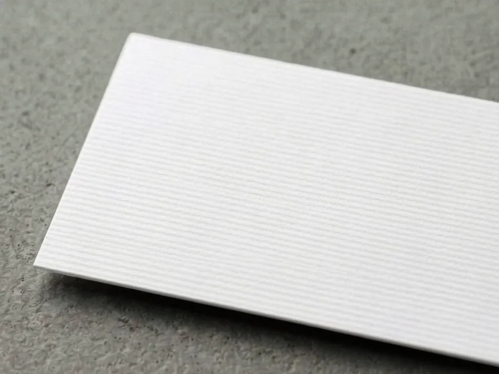 Uncoated Matte Laid cardstock with a distinctive grid-like texture and handcrafted feel, locally produced in NYC for high-end branding and stationery.
