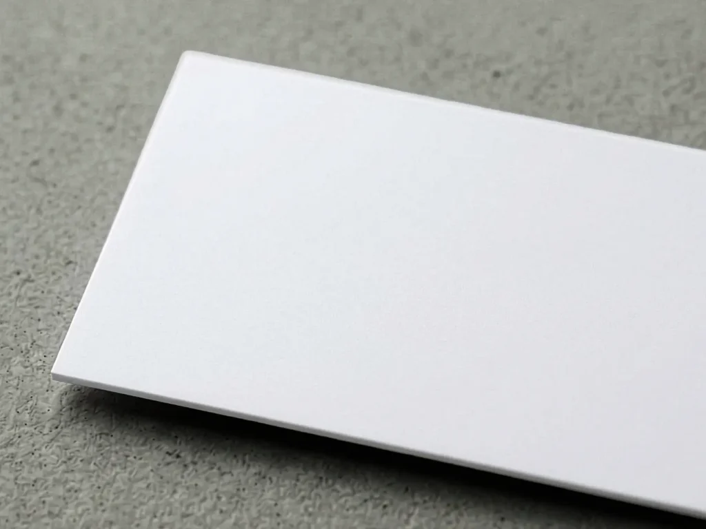 Silk Laminated business card paper with a soft, slightly muted sheen, offering extra durability and a refined feel for modern brands.