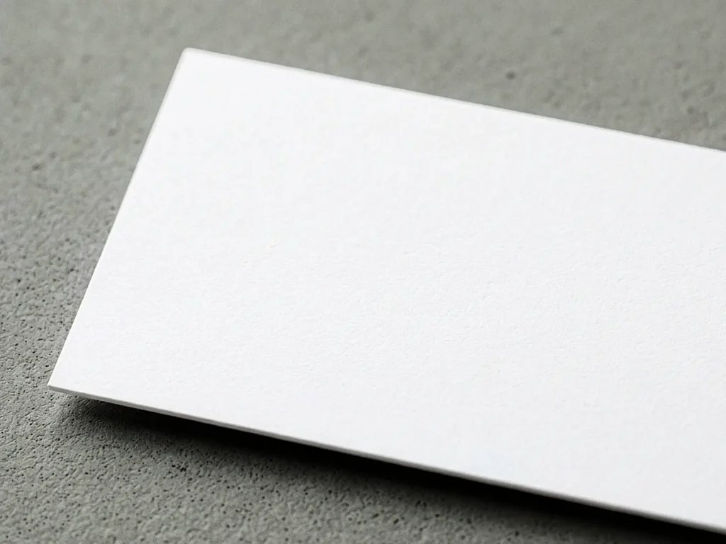 Close-up of Uncoated Smooth business card paper, featuring a natural, writable, and non-shiny finish ideal for minimalist professional designs.